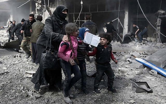 A Syrian woman and children run for cover amid the rubble of buildings following government bombing in the rebel-held town of Hammuriyeh, in the besieged Eastern Ghouta region on the outskirts of the capital Damascus, on February 19, 2018.(AFP Photo/Abdulmonan Eassa) A Syrian woman and children run for cover amid the rubble of buildings following government bombing in the rebel-held town of Hammuriyeh, in the besieged Eastern Ghouta region on the outskirts of the capital Damascus, on February 19, 2018.(AFP Photo/Abdulmonan Eassa)