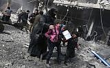 A Syrian woman and children run for cover amid the rubble of buildings following government bombing in the rebel-held town of Hamouria, in the besieged Eastern Ghouta region on the outskirts of the capital Damascus, on February 19, 2018.
(AFP/Abdulmonam Eassa)