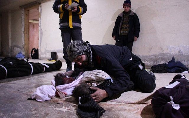 A man weeps over his child at a makeshift morgue in Douma who was killed in airstrikes on the Syrian village of Mesraba in the besieged Eastern Ghouta region on the outskirts of the capital Damascus, on February 19, 2018. (AFP PHOTO / Hamza Al-Ajweh) A man weeps over his child at a makeshift morgue in Douma who was killed in airstrikes on the Syrian village of Mesraba in the besieged Eastern Ghouta region on the outskirts of the capital Damascus, on February 19, 2018. (AFP PHOTO / Hamza Al-Ajweh)