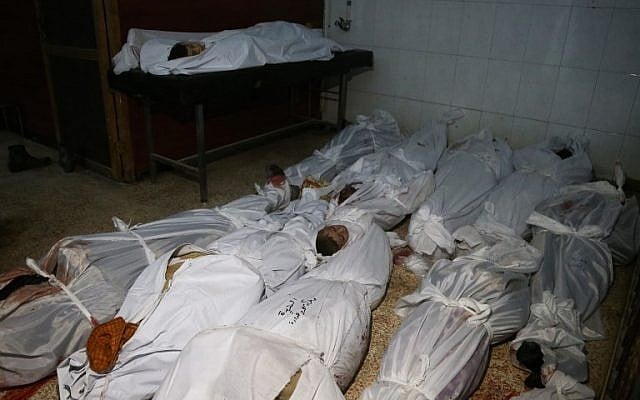 The bodies of civilians who were killed in Syrian army bombardment on the town of Hamouria in the rebel-held enclave of Eastern Ghouta are seen lying on the ground at a make-shift morgue the morning after the attacks on February 20, 2018. (AFP PHOTO / ABDULMONAM EASSA) The bodies of civilians who were killed in Syrian army bombardment on the town of Hamouria in the rebel-held enclave of Eastern Ghouta are seen lying on the ground at a make-shift morgue the morning after the attacks on February 20, 2018. (AFP PHOTO / ABDULMONAM EASSA)