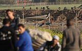 Israeli soldiers observe Palestinian protesters during clashes near the border fence east of Gaza City on February 23, 2018. (AFP Photo/Mohammed Abed)