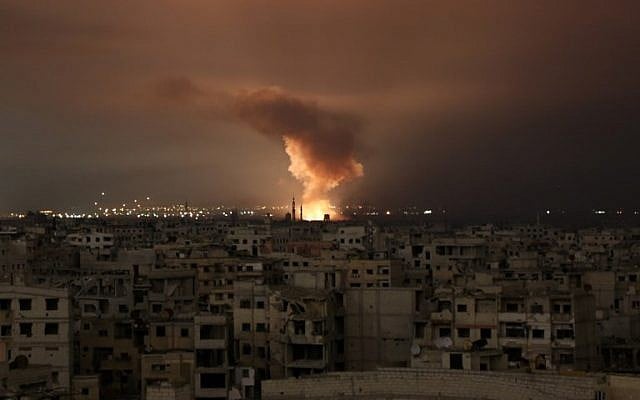 Smoke billows following a regime air strike on the besieged Eastern Ghouta region on the outskirts of the capital Damascus, late on February 23, 2018. (AFP/ Ammar SULEIMAN) Smoke billows following a regime air strike on the besieged Eastern Ghouta region on the outskirts of the capital Damascus, late on February 23, 2018. (AFP/ Ammar SULEIMAN)