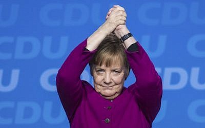 German Chancellor and leader of the Christian Democratic Union (CDU) Angela Merkel cheers after delivering her speech during the party's congress on February 26, 2018 in Berlin. (AFP Photo/Stefanie Loos)
