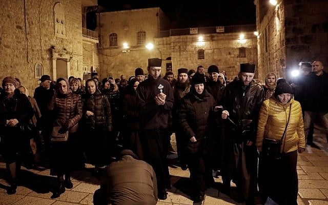 Christian worshippers prepare to enter the Church of the Holy Sepulchre in Jerusalem after it reopened on February 28, 2018, following a three-day closure to protest against Israeli tax measures and a proposed law. (AFP/THOMAS COEX) Christian worshippers prepare to enter the Church of the Holy Sepulchre in Jerusalem after it reopened on February 28, 2018, following a three-day closure to protest against Israeli tax measures and a proposed law. (AFP/THOMAS COEX)