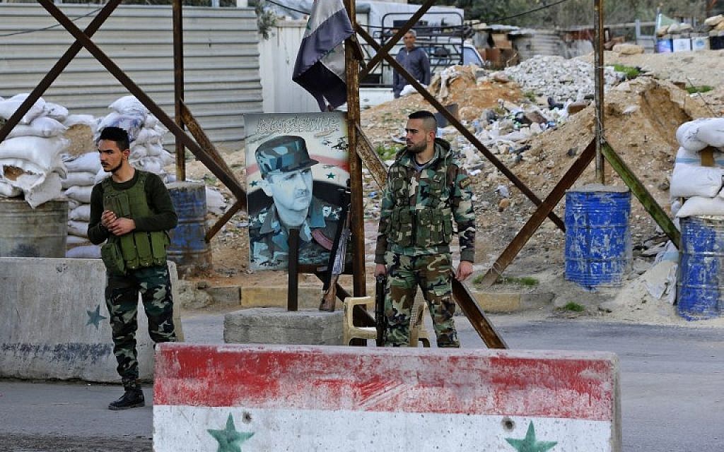 Members of the Syrian government forces stand at the Wafideen checkpoint on the outskirts of Damascus neighboring the rebel-held Eastern Ghouta region on February 28, 2018. (AFP Photo/Louai Beshara) Members of the Syrian government forces stand at the Wafideen checkpoint on the outskirts of Damascus neighboring the rebel-held Eastern Ghouta region on February 28, 2018. (AFP Photo/Louai Beshara)