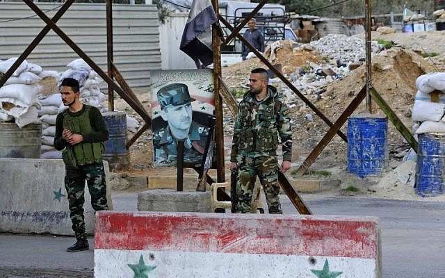 Members of the Syrian government forces stand at the Wafideen checkpoint on the outskirts of Damascus neighboring the rebel-held Eastern Ghouta region on February 28, 2018. (AFP Photo/Louai Beshara) Members of the Syrian government forces stand at the Wafideen checkpoint on the outskirts of Damascus neighboring the rebel-held Eastern Ghouta region on February 28, 2018. (AFP Photo/Louai Beshara)