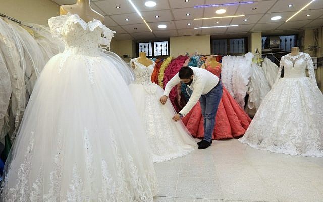 A Syrian man arranges dresses at a wedding gown store in the Syrian capital Damascus on January 8, 2018. (AFP PHOTO / LOUAI BESHARA) A Syrian man arranges dresses at a wedding gown store in the Syrian capital Damascus on January 8, 2018. (AFP PHOTO / LOUAI BESHARA)