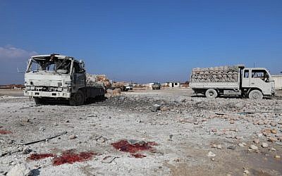 Illustrative: Blood stains on the ground next to trucks loaded with sacks of potatoes standing abandoned, after their windows were blasted from their frames following airstrikes by government forces which hit the vegetable market of the town of Saraqeb in Syria's northwestern province of Idlib, on January 29, 2018. (AFP PHOTO / OMAR HAJ KADOUR)