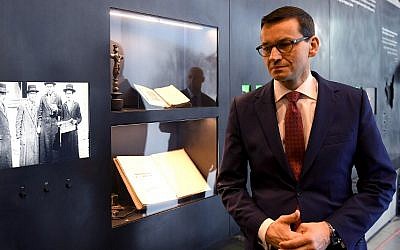 Polands Prime Minister Mateusz Morawiecki visits the Ulma Family Museum that documents the fate of the Polish Ulma family, killed in March 1944 by Nazi Germans for rescuing Jews during the Holocaust, in the village of Markowa, southeastern Poland, on January 2, 2018 (AFP/Janek Skarzynski)