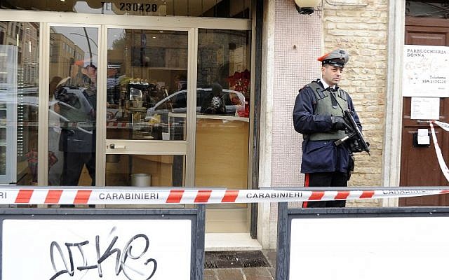 Police officers stand guard as forensics officers carry out investigations in the area following the wounding of several foreign nationals in a drive-by shooting at Macerata, on February 3, 2018. (AFP/ Giuseppe Bellini) Police officers stand guard as forensics officers carry out investigations in the area following the wounding of several foreign nationals in a drive-by shooting at Macerata, on February 3, 2018. (AFP/ Giuseppe Bellini)