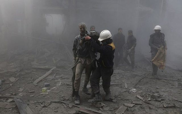 A wounded man is helped out of the destruction following air strikes in the rebel-held enclave of Arbin in the Eastern Ghouta near Damascus on February 8, 2018. (AFP PHOTO / ABDULMONAM EASSA) A wounded man is helped out of the destruction following air strikes in the rebel-held enclave of Arbin in the Eastern Ghouta near Damascus on February 8, 2018. (AFP PHOTO / ABDULMONAM EASSA)