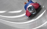 Adam Edelman of Israel corners in his mens skeleton training session at the Olympic Sliding Centre, during the Pyeongchang 2018 Winter Olympic Games in Pyeongchang, South Korea on February 12, 2018. (AFP PHOTO / Mark Ralston)