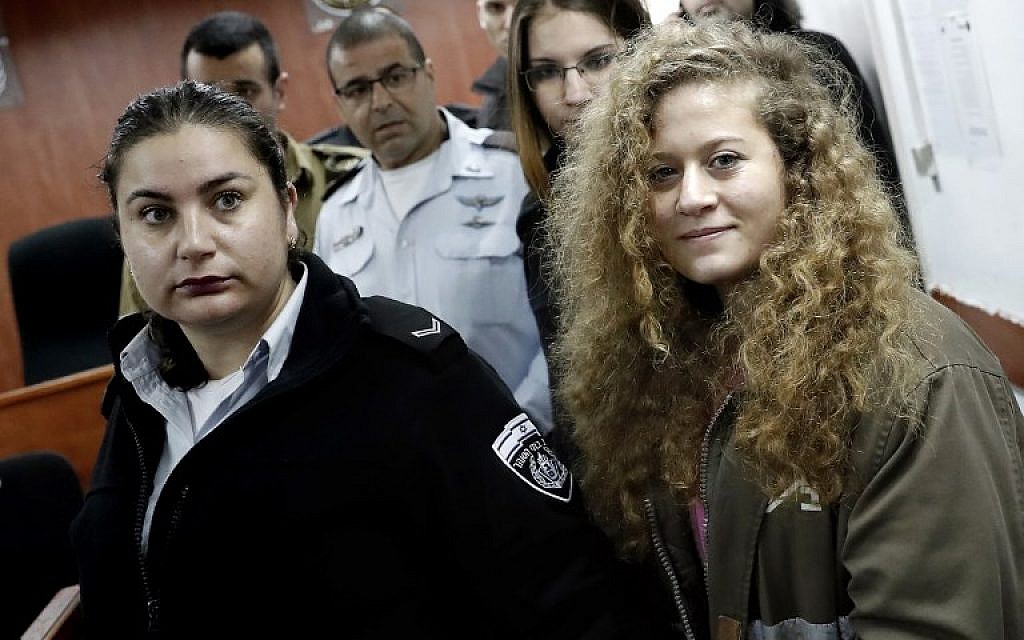 Seventeen-year-old Palestinian Ahed Tamimi, right, arrives for the beginning of her trial in the Israeli military court at Ofer military prison in the West Bank village of Betunia, February 13, 2018. (Thomas Coex/AFP)