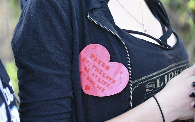 A student wears a Valentine's pin as she leaves Marjory Stoneman Douglas High School in Parkland, Florida, a city about 50 miles (80 kilometers) north of Miami on February 14, 2018 following a school shooting.
A gunman opened fire at the Florida high school, an incident that officials said caused "numerous fatalities" and left terrified students huddled in their classrooms, texting friends and family for help.
The Broward County Sheriff's Office said a suspect was in custody. / AFP PHOTO / Michele Eve Sandberg A student wears a Valentine's pin as she leaves Marjory Stoneman Douglas High School in Parkland, Florida, a city about 50 miles (80 kilometers) north of Miami on February 14, 2018 following a school shooting.
A gunman opened fire at the Florida high school, an incident that officials said caused "numerous fatalities" and left terrified students huddled in their classrooms, texting friends and family for help.
The Broward County Sheriff's Office said a suspect was in custody. / AFP PHOTO / Michele Eve Sandberg