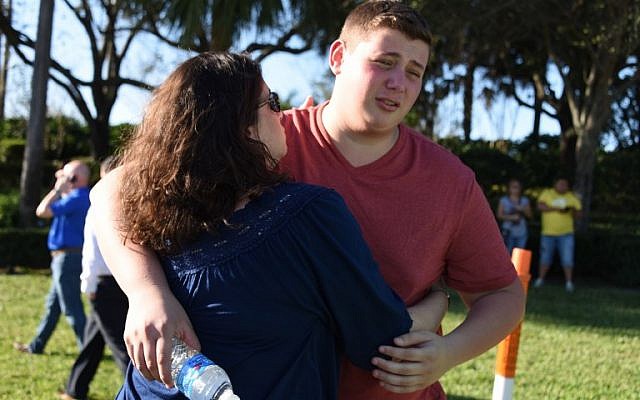 Students react following a shooting at Marjory Stoneman Douglas High School in Parkland, Florida, a city about 50 miles (80 kilometers) north of Miami on February 14, 2018.(AFP PHOTO / Michele Eve Sandberg) Students react following a shooting at Marjory Stoneman Douglas High School in Parkland, Florida, a city about 50 miles (80 kilometers) north of Miami on February 14, 2018.(AFP PHOTO / Michele Eve Sandberg)