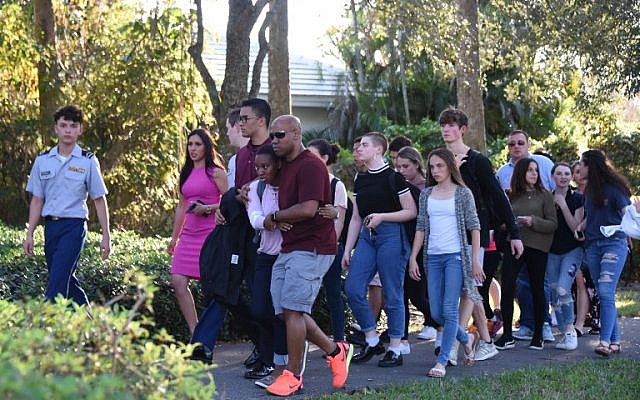 Students react following a shooting at Marjory Stoneman Douglas High School in Parkland, Florida, a city about 50 miles (80 kilometers) north of Miami on February 14, 2018.(AFP PHOTO / Michele Eve Sandberg)