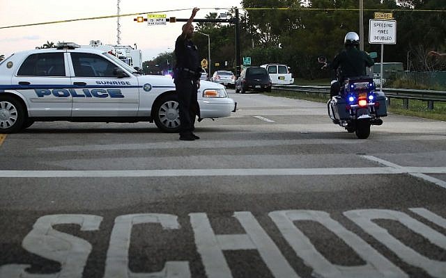 Police control a road near the Marjory Stoneman Douglas High School where 17 people were killed by a gunman on February 15, 2018 in Parkland, Florida. (Mark Wilson/Getty Images/AFP) Police control a road near the Marjory Stoneman Douglas High School where 17 people were killed by a gunman on February 15, 2018 in Parkland, Florida. (Mark Wilson/Getty Images/AFP)