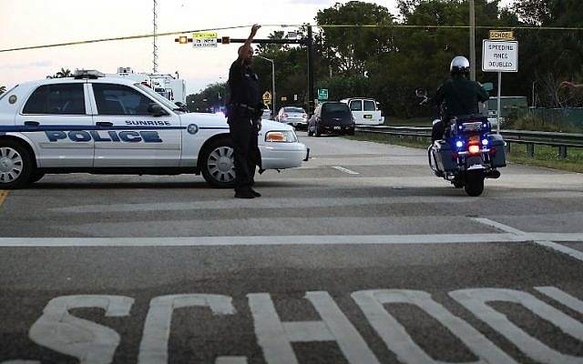 Police control a road near the Marjory Stoneman Douglas High Schoo,l where 17 people were killed by a gunman on February 15, 2018, in Parkland, Florida. (Mark Wilson/Getty Images/AFP) Police control a road near the Marjory Stoneman Douglas High Schoo,l where 17 people were killed by a gunman on February 15, 2018, in Parkland, Florida. (Mark Wilson/Getty Images/AFP)