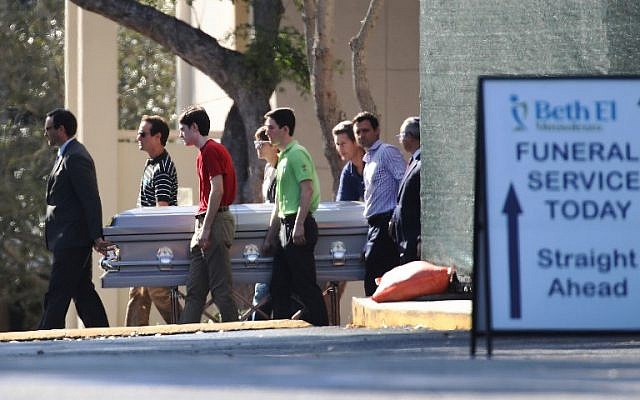 Pallbearers carry the casket of Scott Beigel, geography teacher from Marjory Stoneman Douglas High School, after a funeral service at Temple Beth-El on February 18, 2018 in Boca Raton, Florida. (Joe Raedle/Getty Images/AFP) Pallbearers carry the casket of Scott Beigel, geography teacher from Marjory Stoneman Douglas High School, after a funeral service at Temple Beth-El on February 18, 2018 in Boca Raton, Florida. (Joe Raedle/Getty Images/AFP)