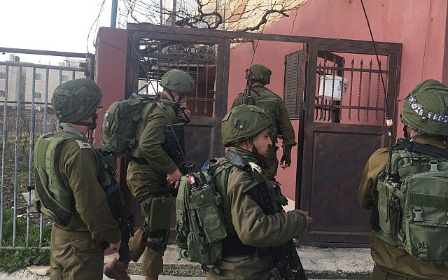 Illustration: Israeli troops walk through the Palestinian town of Halhul, north of Hebron, after a resident stabbed a security guard in a terror attack at a nearby settlement on February 7, 2018. (Israel Defense Forces) Illustration: Israeli troops walk through the Palestinian town of Halhul, north of Hebron, after a resident stabbed a security guard in a terror attack at a nearby settlement on February 7, 2018. (Israel Defense Forces)
