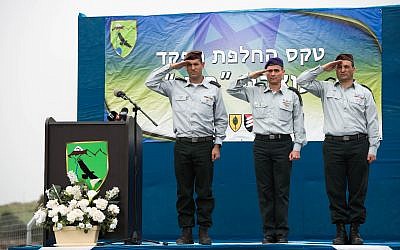 From left, incoming head of the IDF's 210th 'Bashan' Division, Brig. Gen. Amit Fisher; head of the Northern Command, Maj. Gen. Yoel Strick; and outgoing head of the 210th Division, Brig. Gen. Yaniv Assur, salute during a ceremony in the Nafah Army Base on the Golan Heights on February 11, 2018. (Israel Defense Forces)