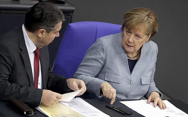 German Chancellor Angela Merkel, right, and German Foreign Minister Sigmar Gabriel, left, talk during a meeting of the German Federal Parliament, Bundestag, at the Reichstag building in Berlin, Germany, February 1, 2018. (AP Photo/Michael Sohn) German Chancellor Angela Merkel, right, and German Foreign Minister Sigmar Gabriel, left, talk during a meeting of the German Federal Parliament, Bundestag, at the Reichstag building in Berlin, Germany, February 1, 2018. (AP Photo/Michael Sohn)