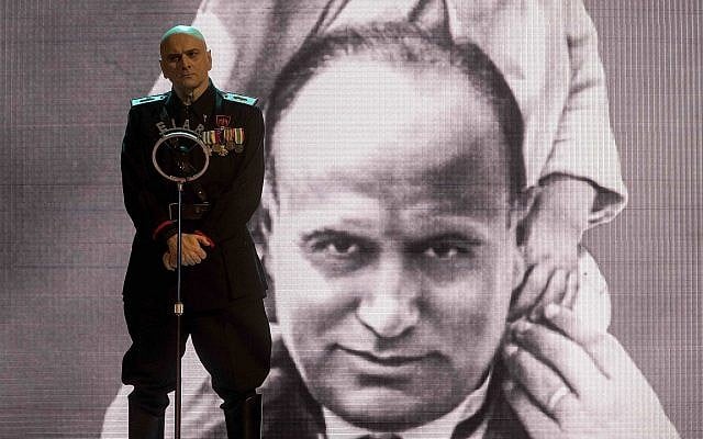 Actor Massimo Popolizio, who plays the part of Benito Mussolini in 'I'm Back,' stands in front of a giant image of the late dictator (Claudio Iannone via AP Photo) Actor Massimo Popolizio, who plays the part of Benito Mussolini in 'I'm Back,' stands in front of a giant image of the late dictator (Claudio Iannone via AP Photo)