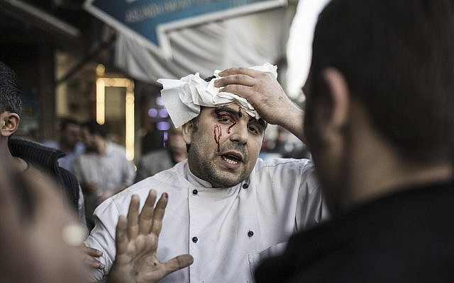 A restaurant worker, wounded in a rocket attack, fired from inside Syria, walks to an ambulance in the border town of Kilis, Turkey on February 1, 2018. (Can Erok/DHA-Depo Photos via AP) A restaurant worker, wounded in a rocket attack, fired from inside Syria, walks to an ambulance in the border town of Kilis, Turkey on February 1, 2018. (Can Erok/DHA-Depo Photos via AP)