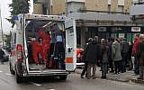 Paramedics attend a wounded man after a shooting broke out in Macerata, Italy, Saturday, Feb. 3, 2018 (Guido Picchio/ANSA via AP)