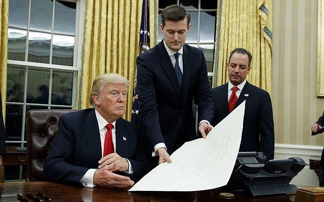 In this January 20, 2017 file photo, White House Staff Secretary Rob Porter, center, hands President Donald Trump a confirmation order for James Mattis as defense secretary, in the Oval Office of the White House in Washington, as White House Chief of Staff Reince Priebus, right, watches. (AP Photo/Evan Vucci) In this January 20, 2017 file photo, White House Staff Secretary Rob Porter, center, hands President Donald Trump a confirmation order for James Mattis as defense secretary, in the Oval Office of the White House in Washington, as White House Chief of Staff Reince Priebus, right, watches. (AP Photo/Evan Vucci)