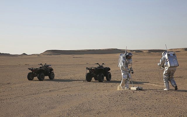 Two scientists in the Dhofar desert of southern Oman test space suits and a geo-radar for use in a future Mars mission, February 7, 2018.  (AP Photo/Sam McNeil)