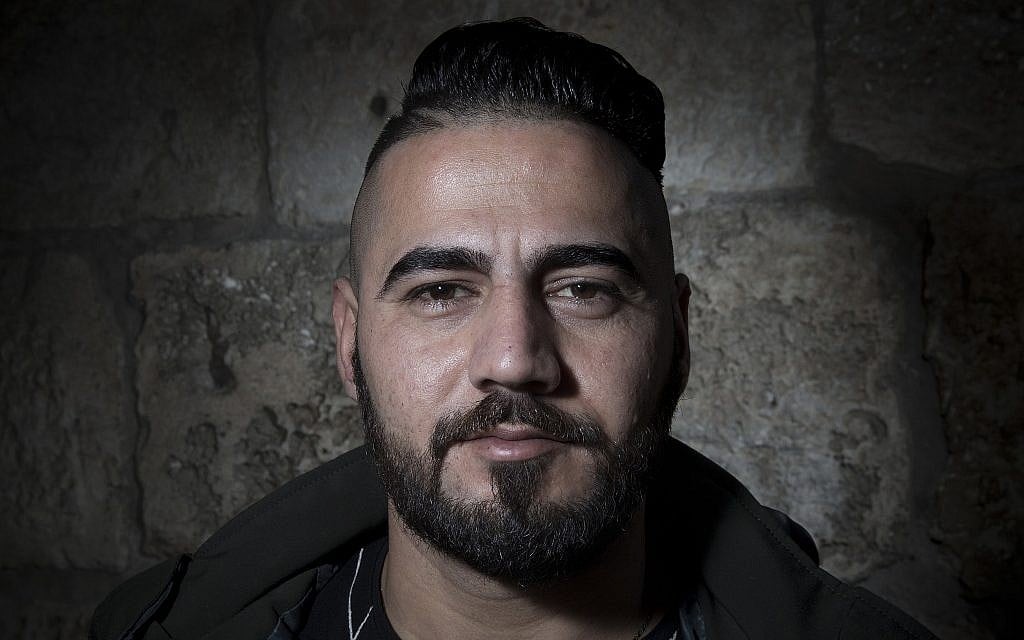 Palestinian Ahmed Jweles poses for a portrait in Jerusalem's Old City, February 11, 2018. (AP Photo/Oded Balilty)