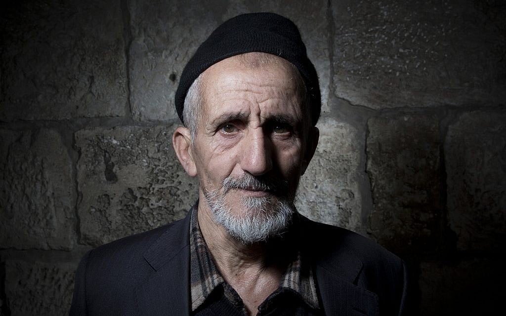 Palestinian Mohammed Asmai poses for a portrait in Jerusalem's Old City, February 11, 2018. (AP Photo/Oded Balilty)