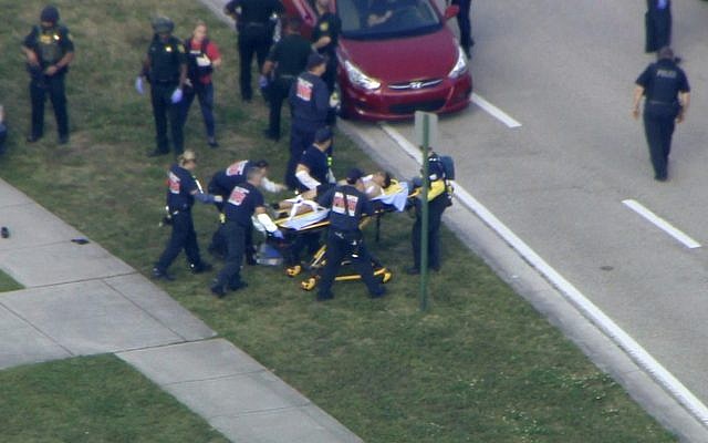 In this frame grab from video provided by WPLG-TV, emergency personnel wheel an injured person from the Marjory Stoneman Douglas High School in Parkland, Fla., following a shooting there on February 14, 2018. (WPLG-TV via AP) In this frame grab from video provided by WPLG-TV, emergency personnel wheel an injured person from the Marjory Stoneman Douglas High School in Parkland, Fla., following a shooting there on February 14, 2018. (WPLG-TV via AP)