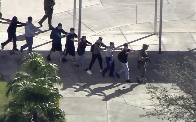 In this frame grab from video provided by WPLG-TV, students from the Marjory Stoneman Douglas High School in Parkland, Fla., evacuate the school following a shooting on February 14, 2018. (WPLG-TV via AP) In this frame grab from video provided by WPLG-TV, students from the Marjory Stoneman Douglas High School in Parkland, Fla., evacuate the school following a shooting on February 14, 2018. (WPLG-TV via AP)