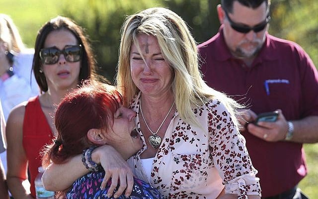 Parents wait for news after reports of a shooting at Marjory Stoneman Douglas High School in Parkland, Florida., on February 14, 2018. (AP Photo/Joel Auerbach) Parents wait for news after reports of a shooting at Marjory Stoneman Douglas High School in Parkland, Florida., on February 14, 2018. (AP Photo/Joel Auerbach)