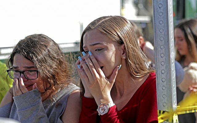Students released from a lockdown are overcome with emotion following following a shooting at Marjory Stoneman Douglas High School in Parkland, Florida on Feb. 14, 2018. (John McCall/South Florida Sun-Sentinel via AP)
