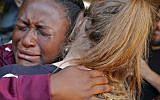 Marla Eveillard, 14, cries as she hugs friends before the start of a vigil at the Parkland Baptist Church, for the victims of Wednesday's shooting at the Marjory Stoneman Douglas High School in Parkland, Florida, February 15, 2018. (AP Photo/Gerald Herbert)