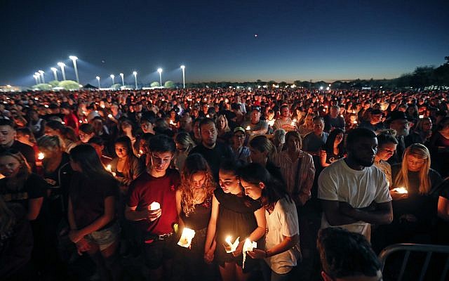 People attend a candlelight vigil for the victims of the Wednesday shooting at Marjory Stoneman Douglas High School, in Parkland, Florida,, February 15, 2018. (AP Photo/Gerald Herbert) People attend a candlelight vigil for the victims of the Wednesday shooting at Marjory Stoneman Douglas High School, in Parkland, Florida,, February 15, 2018. (AP Photo/Gerald Herbert)
