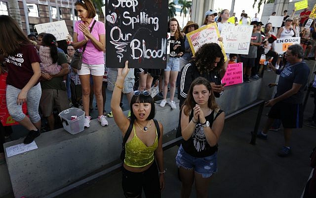 Demonstrators at protest against guns on the steps of the Broward County Federal courthouse in Fort Lauderdale, Florida, on Saturday, February 17, 2018. (AP Photo/Brynn Anderson)