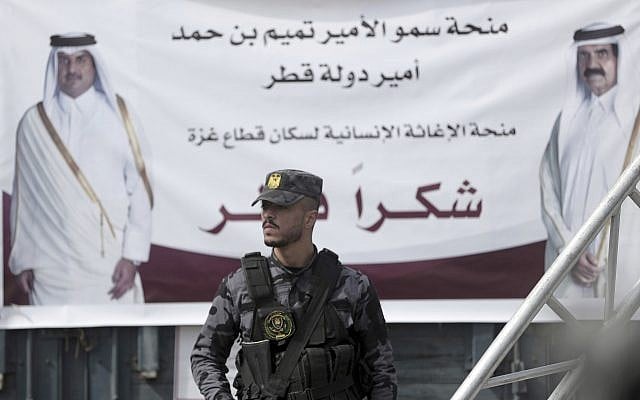 A Palestinian Hamas member stands guard in front of a poster of Qatar's Emir, Sheikh Tamim bin Hamad Al Thani, left, and former Emir of Qatar, Sheikh Hamad bin Khalifa Al Thani, during a press conference with Matthias Schmale, UNRWA's director in Gaza, and the Qatari envoy, Mohammed Al-Emadi, at the Shifa Hospital in Gaza City, Gaza, on February 19, 2018. (AP Photo/ Khalil Hamra) A Palestinian Hamas member stands guard in front of a poster of Qatar's Emir, Sheikh Tamim bin Hamad Al Thani, left, and former Emir of Qatar, Sheikh Hamad bin Khalifa Al Thani, during a press conference with Matthias Schmale, UNRWA's director in Gaza, and the Qatari envoy, Mohammed Al-Emadi, at the Shifa Hospital in Gaza City, Gaza, on February 19, 2018. (AP Photo/ Khalil Hamra)