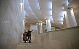 In this February 7, 2018, photo, Reza Daneshmir, right, gestures as he talks with his wife Catherine Spiridonoff, both architects of Vali-e-Asr mosque, while they walk on one of the mosque's ramps, in Tehran, Iran. (AP Photo/Vahid Salemi)