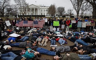 Demonstrators participate in a "lie-in" during a protest in favor of gun control reform in front of the White House, Monday, Feb. 19, 2018, in Washington. (AP Photo/Evan Vucci)