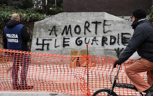A forensic police officer looks at graffiti reading in Italian "Death to the cops" on a vandalized monument honoring police killed by Red Brigades terrorists, in Rome, February 21, 2018. (Alessandro Di Meo/ANSA via AP) A forensic police officer looks at graffiti reading in Italian "Death to the cops" on a vandalized monument honoring police killed by Red Brigades terrorists, in Rome, February 21, 2018. (Alessandro Di Meo/ANSA via AP)