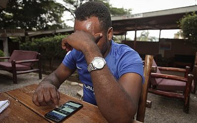 In this Sunday, February 11, 2018, photo, Eritrean migrant Yohannes Tesfagabr, one of the tens of thousands of African migrants Israel has targeted for deportation, recounts his journey to The Associated Press in Kampala, Uganda. (AP Photo/Stephen Wandera)