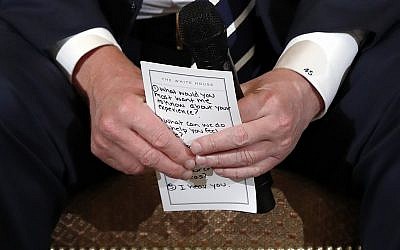 US President Donald Trump holds notes during a listening session with high school students and teachers in the State Dining Room of the White House in Washington February 21, 2018. (AP Photo/Carolyn Kaster)