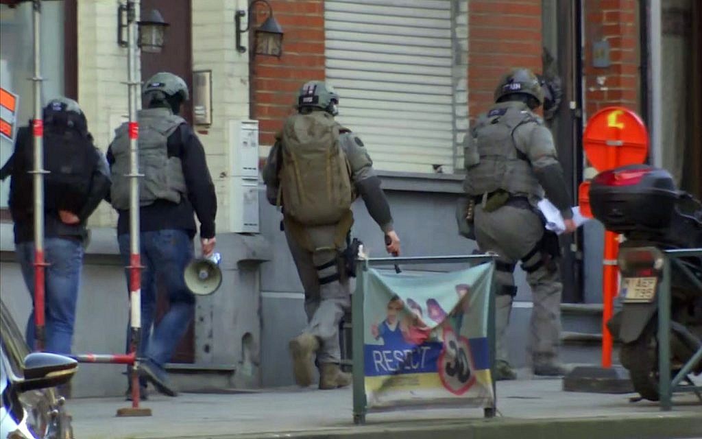 Belgium security personnel enter a building in Brussels in this image taken from TV Thursday Feb. 22, 2018. (AP Photo)