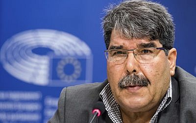 In this Sept. 1, 2016, file photo, then co-chair of the Syrian Kurdish Democratic Union Party (PYD) Salih Muslim addresses journalists at the European Parliament in Brussels. (AP Photo/Geert Vanden Wijngaert, File)