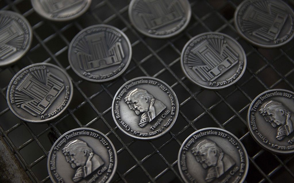 Coins bearing the images of US President Donald Trump and King Cyrus, to honor Trump's recognition of Jerusalem as Israel's capital, are laid out at a private minting facility in Tel Aviv on February 28, 2018. (AP Photo/Sebastian Scheiner) Coins bearing the images of US President Donald Trump and King Cyrus, to honor Trump's recognition of Jerusalem as Israel's capital, are laid out at a private minting facility in Tel Aviv on February 28, 2018. (AP Photo/Sebastian Scheiner)