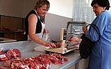 A consumer buys meat in Warsaw, Poland, Friday July 9, 2004. After Poland joined the European Union on May 1st, food prices increased in the country, with the sharpest rise,  21.7 percent, for meat.(AP/Alik Keplicz)